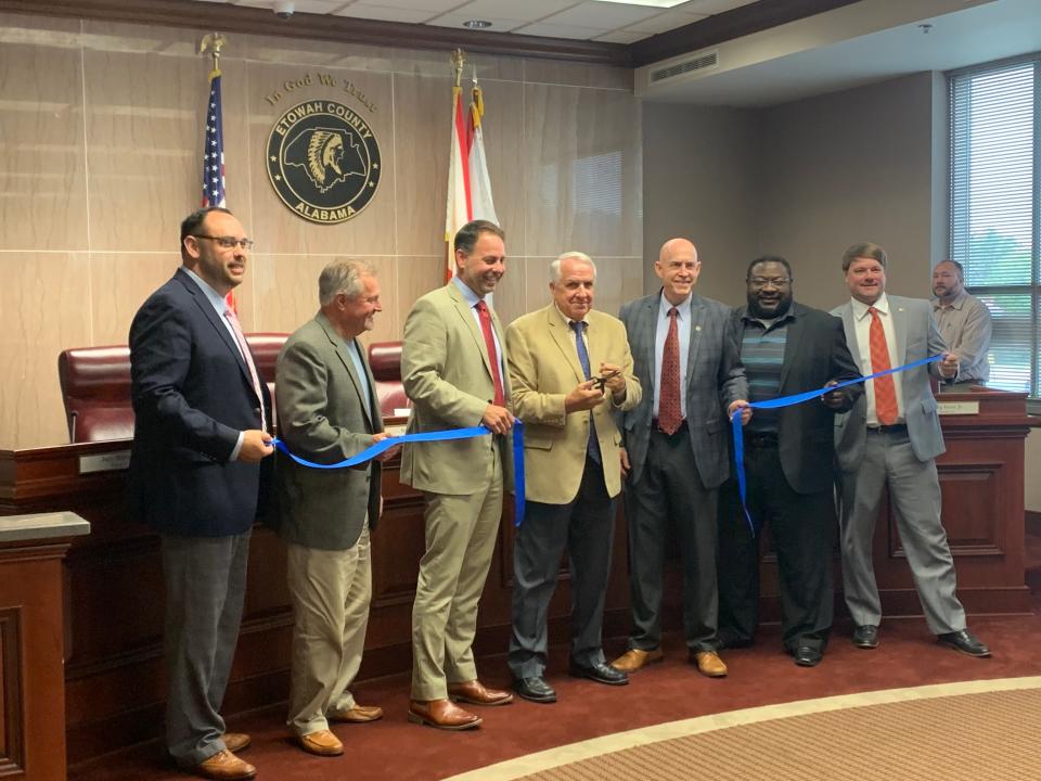 Etowah County Commissioners showcase support for child abuse awareness in Etowah County with their annual cutting of a blue ribbon.