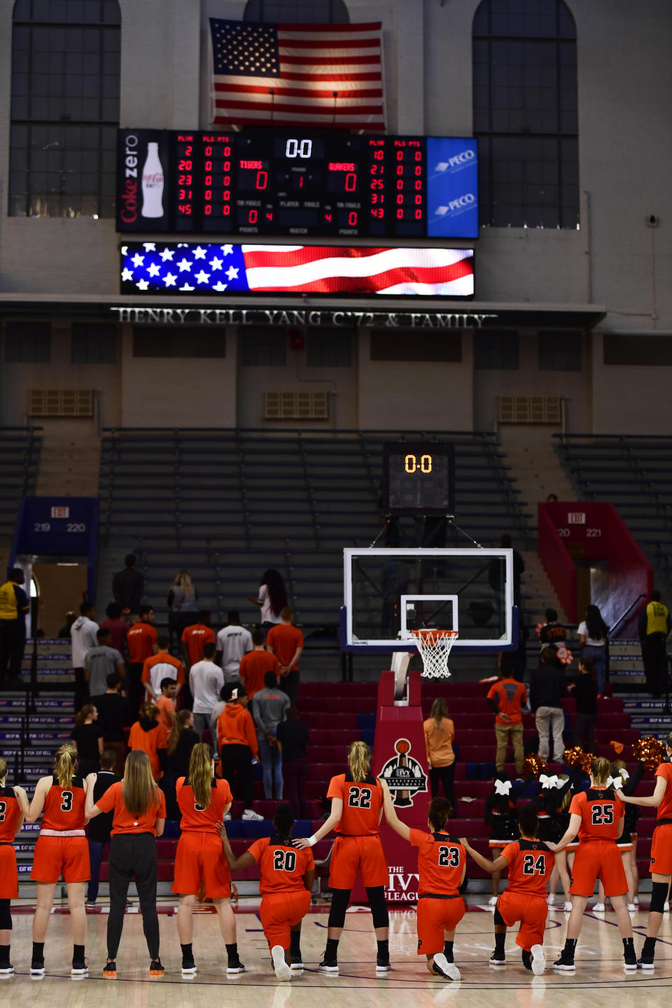 Sydney Jordan #20, Qalea Ismail #23 and Kenya Holland #24 of the Princeton Tigers kneel during the national anthem before the game at The Palestra on March 11, 2018 in Philadelphia, Pennsylvania. Princeton defeated Penn 63-34 for the Women's Ivy League Tournament Championship title. (Photo by Corey Perrine/Getty Images)