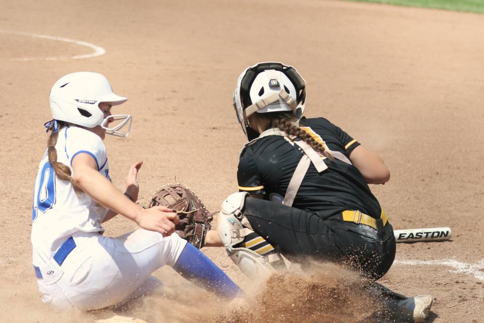 Hilliard Bradley's Andrea Day slides safely with the winning run in Saturday's district final against Dresden Tri-Valley.