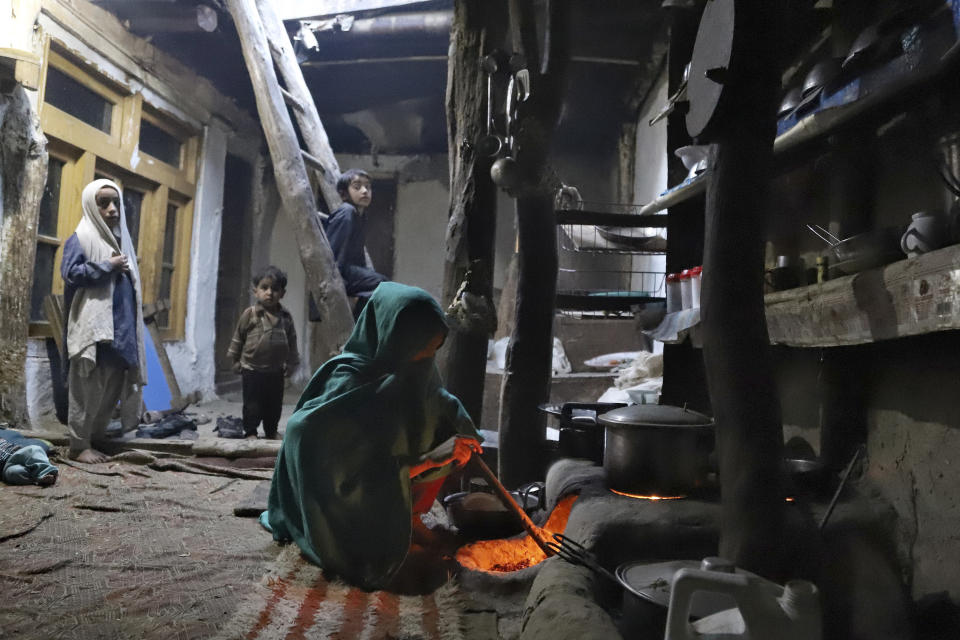 A sister of Mohammed Hassan, a Pakistani porter who died on July 27 during a summit of K2, prepares food at her home in Tasar, a village in the Shigar district in the Gilgit-Baltistan region of northern Pakistan, Saturday, Aug. 12, 2023. An investigation has been launched into the death of a Hassan near the peak of the world's most treacherous mountain, a Pakistani mountaineer said Saturday, following allegations that dozens of climbers eager to reach the summit had walked past the man after he was gravely injured in a fall. (AP Photo/M.H. Balti)