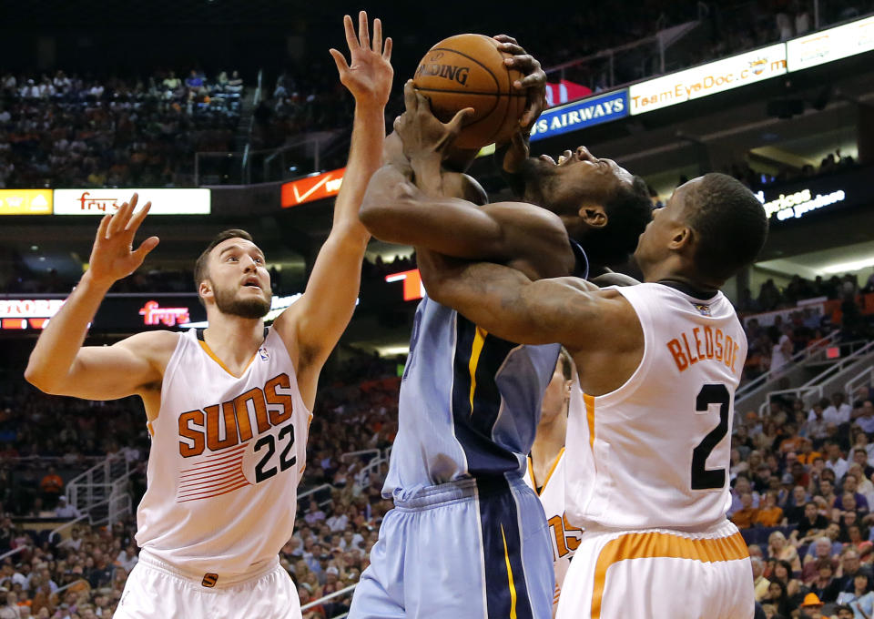 Memphis Grizzlies' Tony Allen, center, is fouled by Phoenix Suns' Eric Bledsoe (2) as Miles Plumlee (22) defends during the first half of an NBA basketball game, Monday, April 14, 2014, in Phoenix. (AP Photo/Matt York)