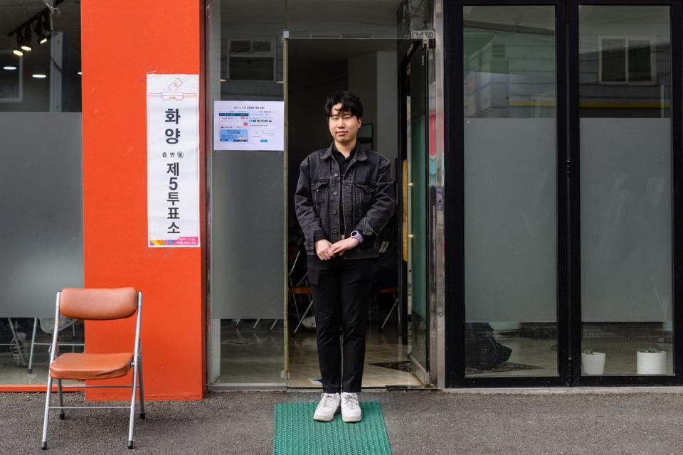 Kim Yong-ho, 24, who owns a food and beverages business, poses outside a polling station in Seoul on 10 April 2024, after voting for the first time, during the parliamentary election (AFP via Getty Images)