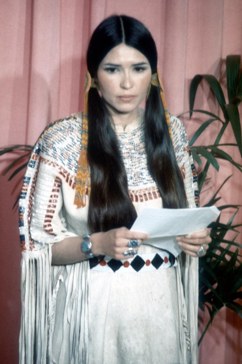 Sacheen Littlefeather (Native American actress Maria Cruz) holds a written statement from actor Marlon Brando refusing his Best Actor Oscar on stage at the Academy Awards on March 27, 1973 in Los Angeles, California.