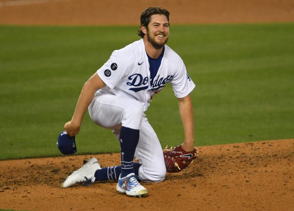 Los Angeles Dodgers starting pitcher Trevor Bauer (27) reacts after landing on the dirt as he avoided a line drive from San Diego Padres first baseman Eric Hosmer in the sixth inning at Dodger Stadium on April 24.