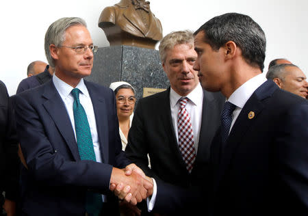 British ambassador to Venezuela Andrew Keith Sope, next to German ambassador to Venezuela Daniel Martin Kriener, and Venezuelan opposition leader Juan Guaido, who many nations have recognized as the country's rightful interim ruler, shake hands during a news conference with accredited diplomatic representatives of the European Union in Caracas, Venezuela February 19, 2019. REUTERS/Marco Bello