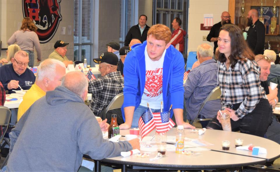 West Holmes students Grant Miller and Olivia Sampsel visit with veterans during the Veterans Day breakfast hosted by the West Holmes History Club.
