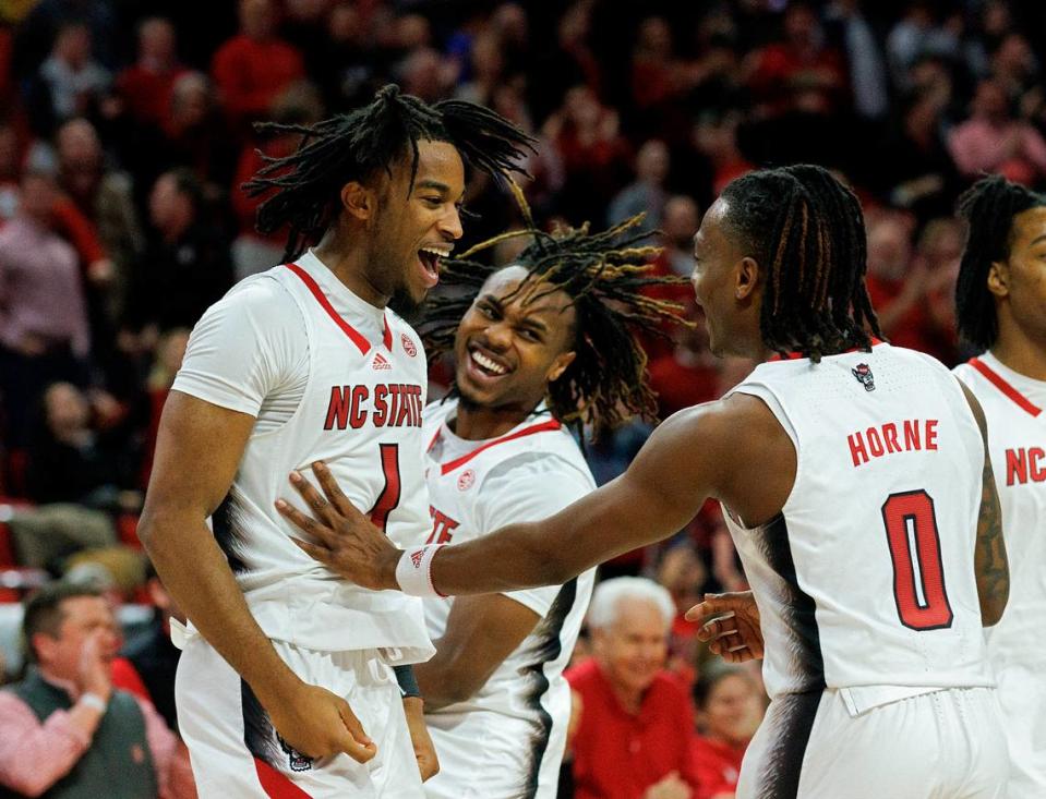 N.C. State’s Jayden Taylor celebrates with teammates Kam Woods and DJ Horne late in the second half of the Wolfpack’s 83-76 win over Wake Forest at PNC Arena on Tuesday, Jan. 16, 2024, in Raleigh, N.C.