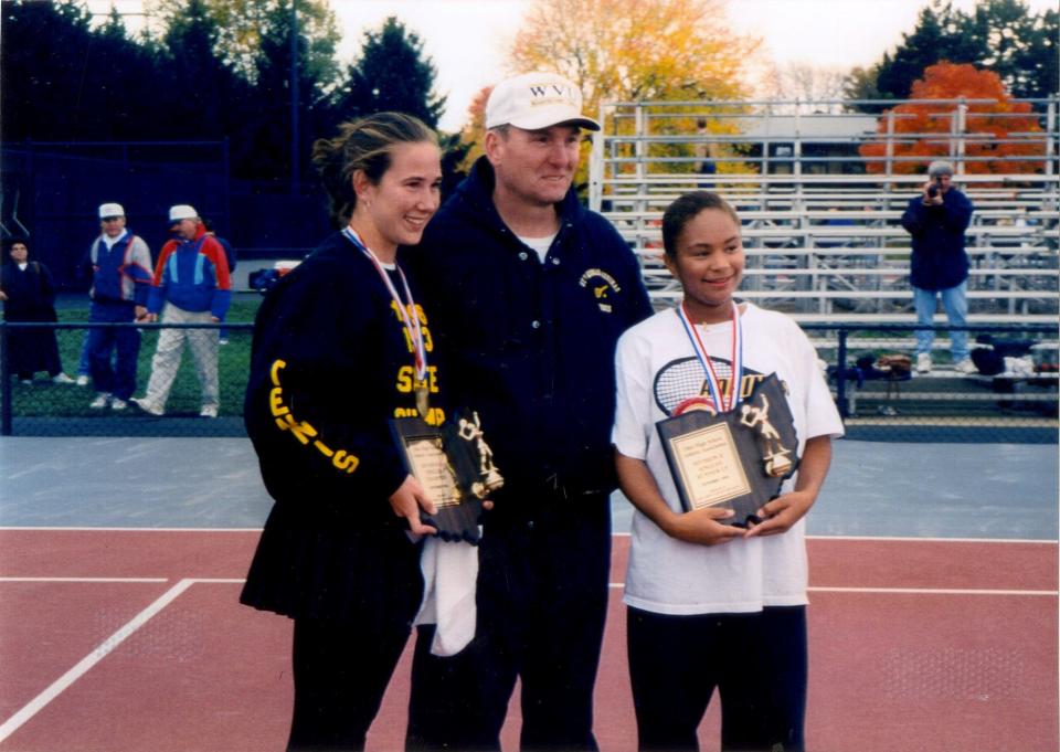 Aquinas girls tenis coach Ryan Shaffer poses with state singles champion Celena McCoury, left, and runner-up Christina Denny following their all-Aquinas title match in 1996.