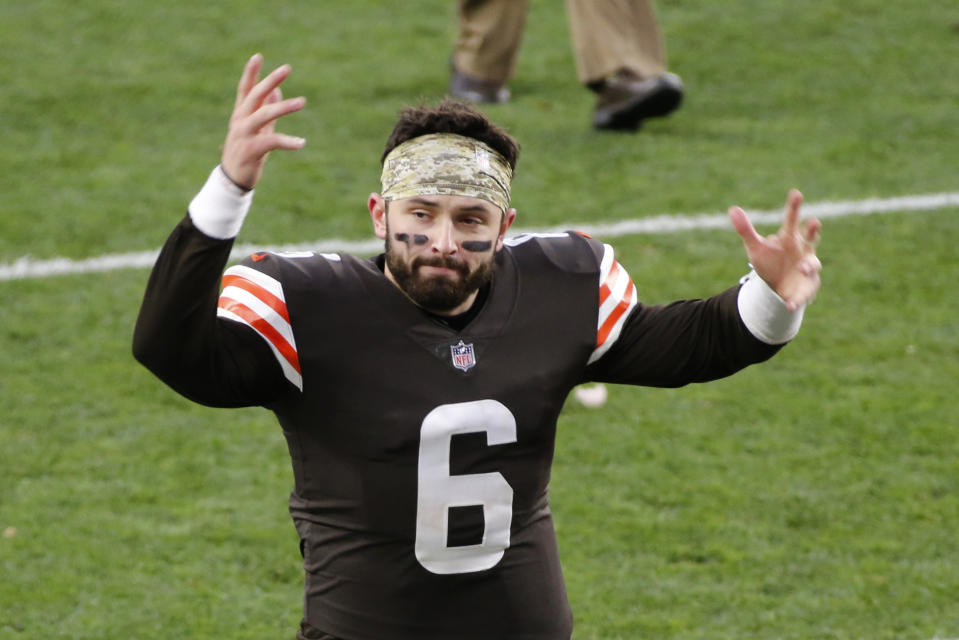 Cleveland Browns quarterback Baker Mayfield, no helmet, hands up.