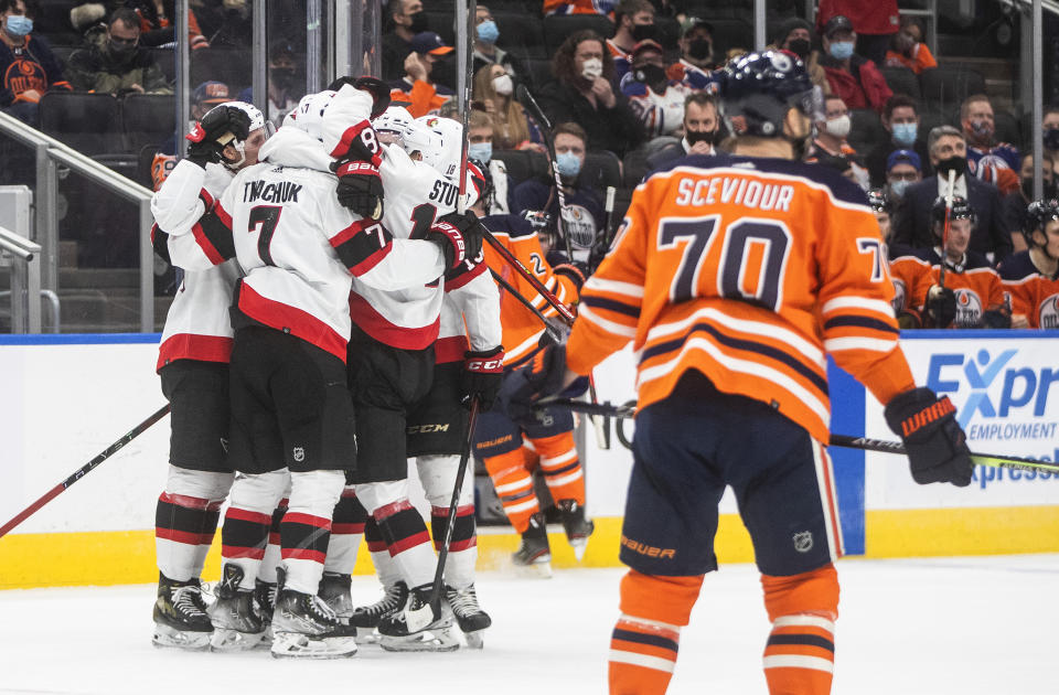 Ottawa Senators players celebrate a goal against the Edmonton Oilers during the third period of an NHL hockey game, Saturday, Jan. 15, 2022 in Edmonton, Alberta. (Jason Franson/The Canadian Press via AP)