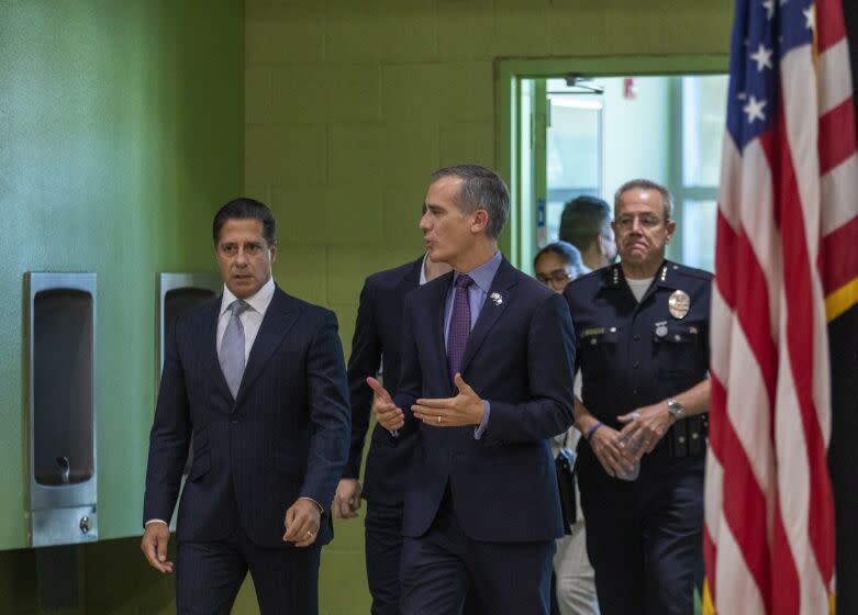 Los Angeles, CA - September 06: Superintendent of Los Angeles Unified School District Alberto M. Carvalho, left, Los Angeles Mayor Eric Michael Garcetti, middle, and Los Angeles Police Department Chef Michel Moore, right, walk into a press conference at Edward R. Roybal Learning Center on Tuesday, Sept. 6, 2022, in Los Angeles, CA. There's been a major cyberattack on the Los Angeles Unified School District. Major problems over the weekend. (Francine Orr / Los Angeles Times)