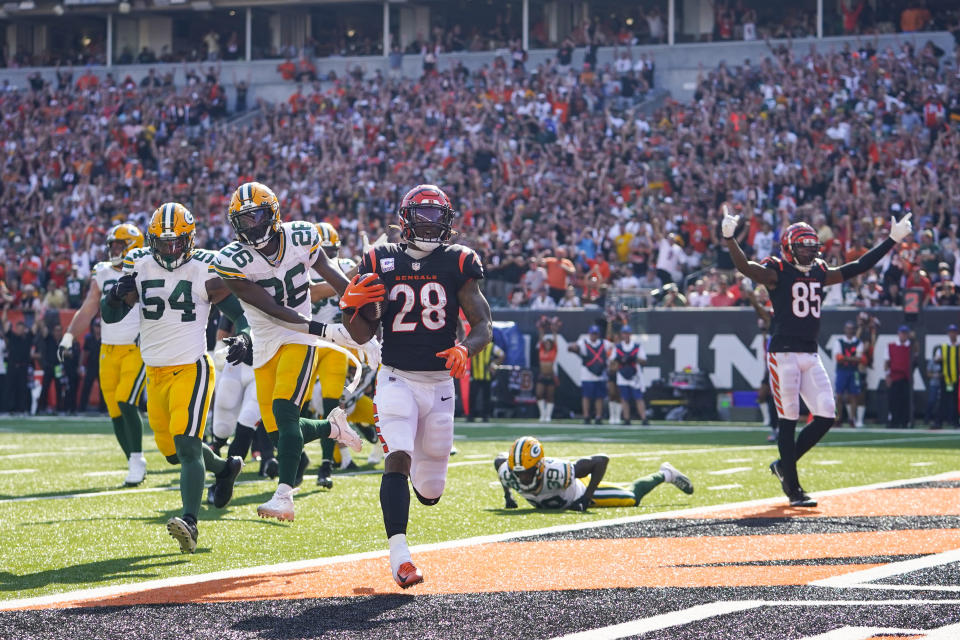 Cincinnati Bengals running back Joe Mixon (28) runs in for a touchdown against the Green Bay Packers in the second half of an NFL football game in Cincinnati, Sunday, Oct. 10, 2021. (AP Photo/Bryan Woolston)