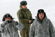 Russian officers look at international journalists who arrived on the Alexandra Land island near Nagurskoye, Russia, Monday, May 17, 2021. Once a desolate home mostly to polar bears, Russia's northernmost military outpost is bristling with missiles and radar and its extended runway can handle all types of aircraft, including nuclear-capable strategic bombers, projecting Moscow's power and influence across the Arctic amid intensifying international competition for the region's vast resources. (AP Photo/Alexander Zemlianichenko)