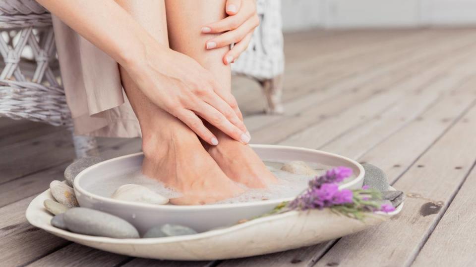 Toe cramps: Close-up of woman having a footbath