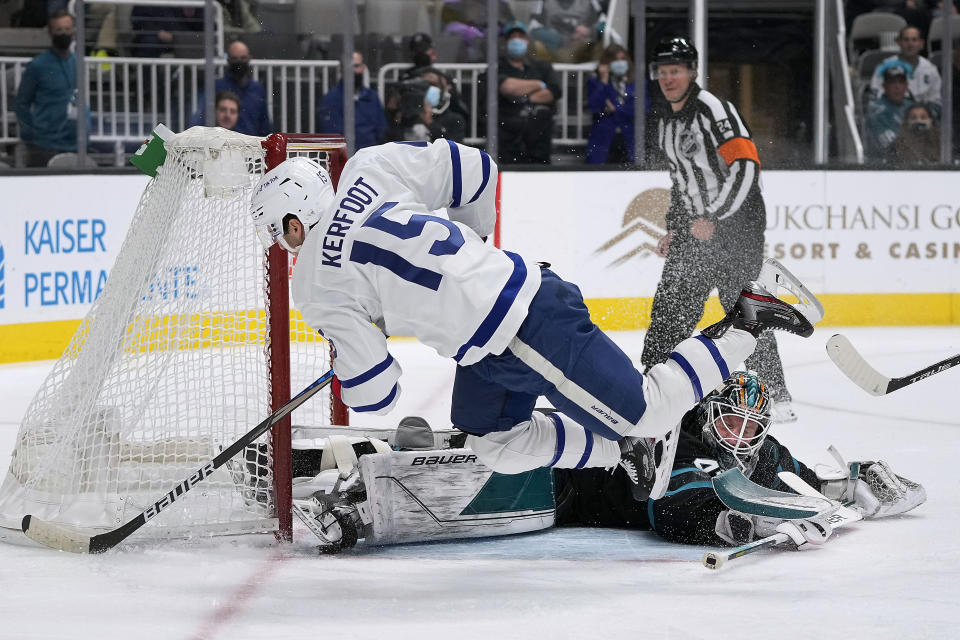 San Jose Sharks goaltender James Reimer (47) stops a shot by Toronto Maple Leafs center Alexander Kerfoot (15) during the second period of an NHL hockey game Friday, Nov. 26, 2021, in San Jose, Calif. (AP Photo/Tony Avelar)