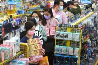 People queue to buy face masks at a store, following the outbreak of coronavirus disease (COVID-19), in Taipei