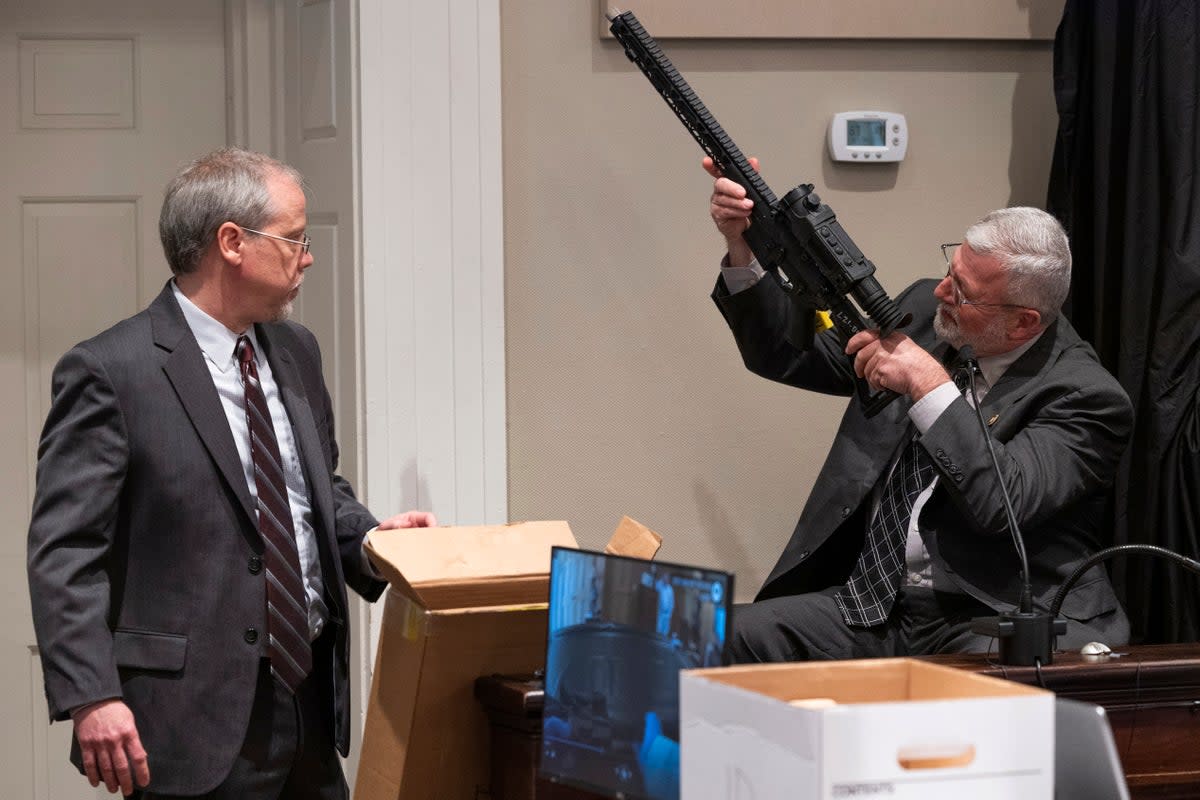 Prosecutor Creighton Waters and witness Jeff Croft, a SLED senior special agent, show jurors one of the guns taken from the Murdaugh property (2022 The State Media Company)