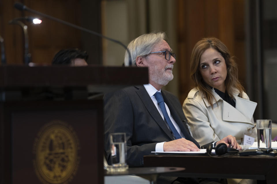 Ecuador's ambassador Andres Teran Parral, left, and agent Ana Maria Larrea, right, wait for judges to enter the International Court of Justice in The Hague, Netherlands, Tuesday, April 30, 2024, where Mexico is taking Ecuador to the United Nations' top court accusing the nation of violating international law by storming into the Mexican embassy in Quito and arresting former Ecuador Vice President Jorge Glas, who had been holed up there seeking asylum in Mexico. (AP Photo/Peter Dejong)