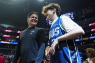 Mark Cuban and his son, Jake Cuban, stand on the sideline before Game 1 of an NBA basketball first-round playoff series against the LA Clippers in Los Angeles, Sunday, April 21, 2024. (AP Photo/Ashley Landis)