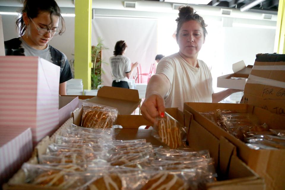 Natasha Gaskill, right, is joined by a group of volunteers as they box up cookies to sell as the Plan C: Cookies for Choice fundraiser for Planned Parenthood Southeast.