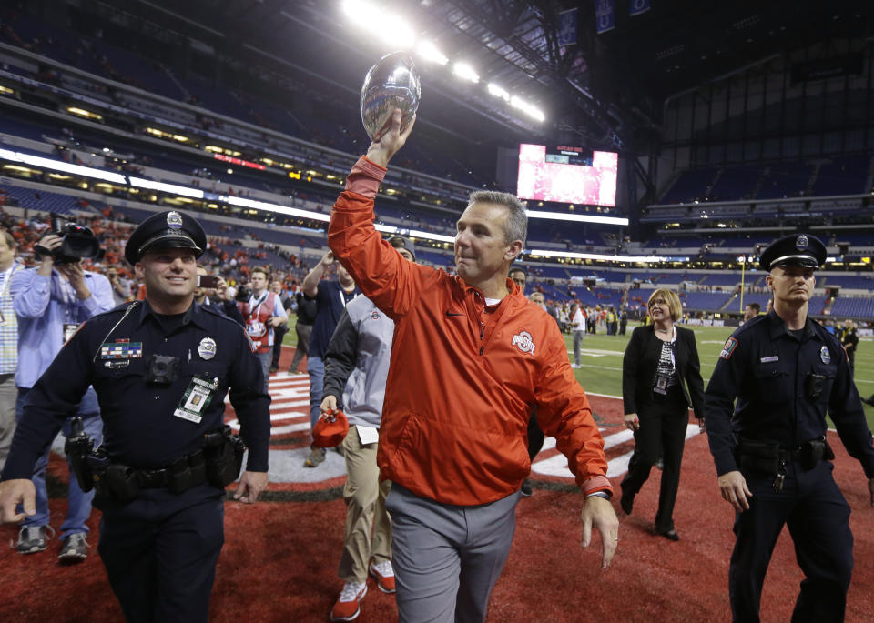 Ohio State coach Urban Meyer holds the trophy following the team’s Big Ten championship NCAA college football game against Wisconsin, early Sunday, Dec. 3, 2017, in Indianapolis. Ohio State won 27-21. (AP Photo/Michael Conroy)