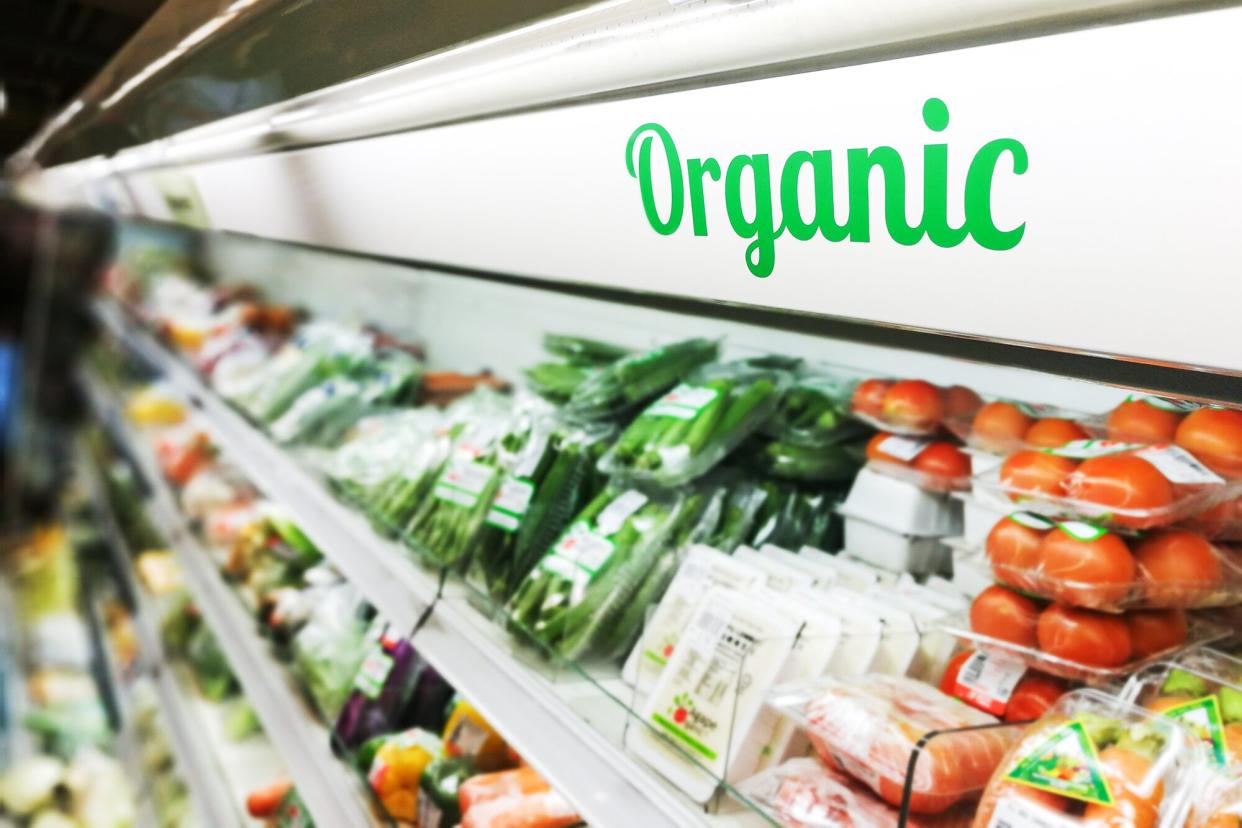 Organic food signage on modern supermarket fresh produce vegetable aisle