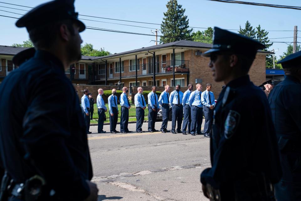 Police cadets stand in line to enter a funeral service in honor of Detroit Police Officer Loren Michael Courts, a five-year veteran of the 2nd Precinct Special Operations Cease Fire Unit, outside of Greater Grace Temple in Detroit on Monday July 18, 2022. Courts was was shot and killed after being ambushed by a gunman in Detroit's west side on July 6, 2022.
