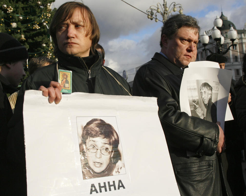 FILE - Liberal Yabloko party leader Grigory Yavlinsky holds a portrait of Yuri Shchekochikhin, right, while an unidentified participant holds a portrait of Anna Politkovskaya, left, during an unauthorized rally to commemorate journalists, who had been killed in Russia, Moscow on Dec. 17, 2006. Kremlin critics, turncoat spies and investigative journalists have been attacked or killed in a variety of ways. Assassination attempts against foes of President Vladimir Putin have been common during his nearly quarter century in power. Novaya Gazeta journalists Politkovskaya was shot and killed in the elevator of her Moscow apartment building in 2006 and Shchekochikhin died of a sudden and violent illness in 2003. (AP Photo/Misha Japaridze, File)