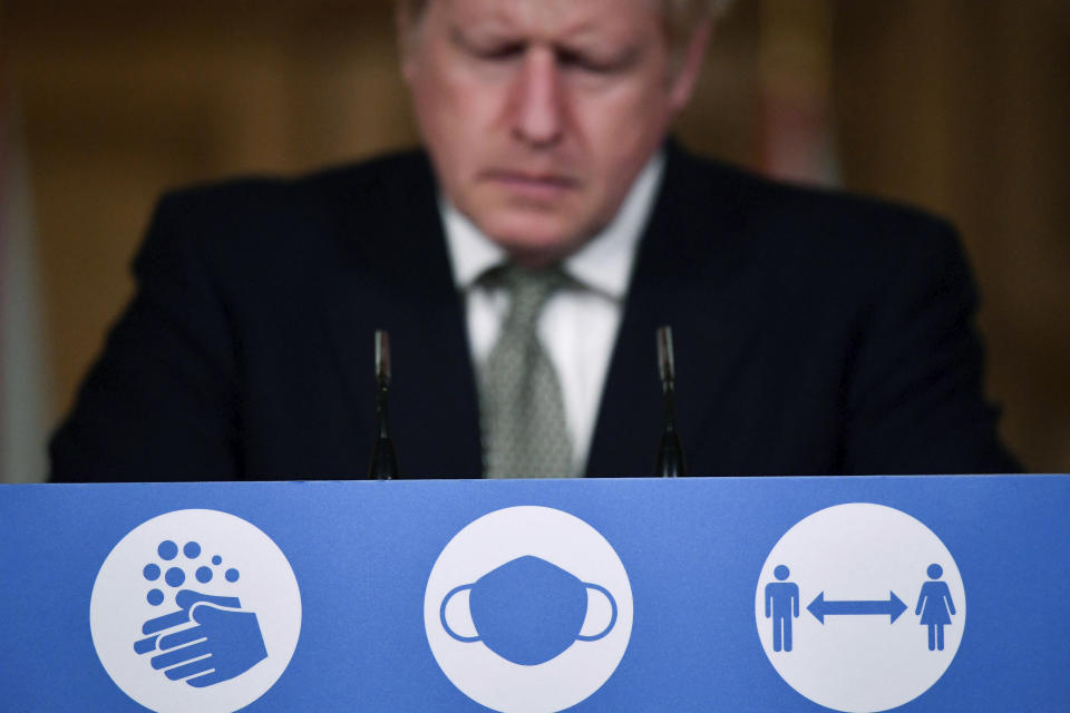 Britain's Prime Minister Boris Johnson listens during a coronavirus briefing in Downing Street, London, Monday, Oct. 12, 2020. (Toby Melville/Pool Photo via AP)