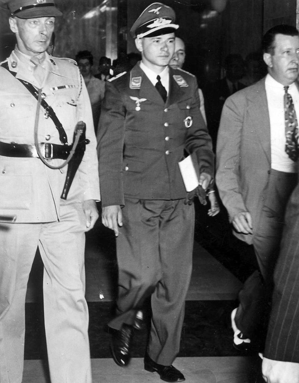Prisoner of war Lt. Hans Peter Krug, center, is escorted into court in 1942. Krug testified at the trial of Max Stephan, who was charged with treason for helping the German airman escape.