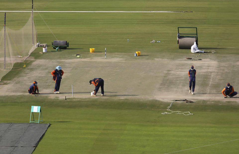 Ground staff prepare bitches for the upcoming country's premier domestic Twenty20 tournament 'Pakistan Super League' at the National Stadium, in Karachi, Pakistan, Tuesday, Jan. 25, 2022. The Pakistan Cricket Board says "robust" COVID-19 health and safety protocols are in place ahead of its month-long domestic Twenty20 competition in Karachi and Lahore, with several foreign cricketers participating in a six-team event. (AP Photo/Fareed Khan)