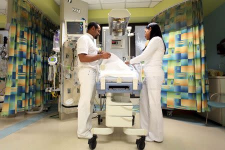 Nurses attend to a young patient at the Cardiovascular Center of Puerto Rico and the Caribbean in San Juan, October 21, 2015. REUTERS/Alvin Baez