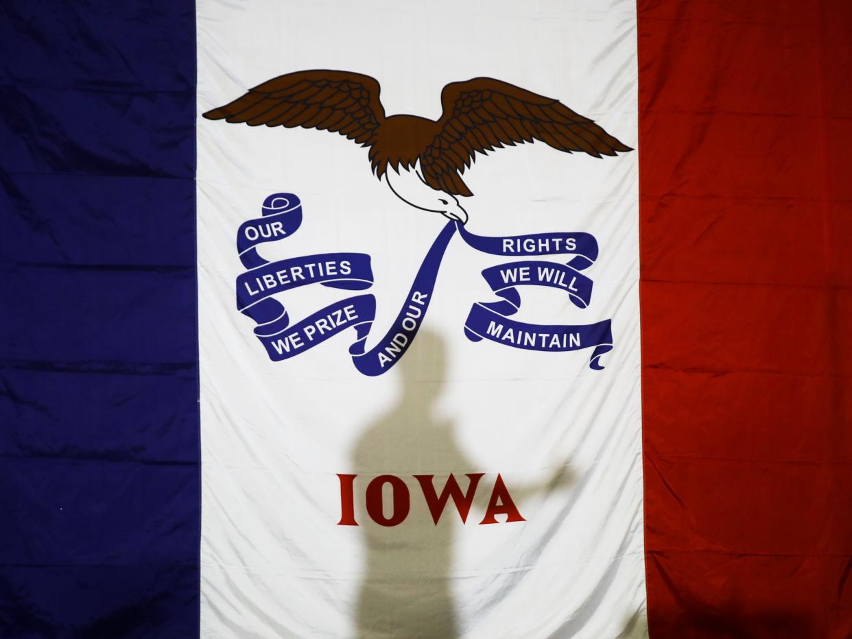 Democratic presidential candidate former South Bend, Ind., Mayor Pete Buttigieg's shadow is cast on the Iowas state flag as he speaks during a campaign event at Northwest Junior High, Sunday, Feb. 2, 2020, in Coralville, Iowa. (AP Photo/Matt Rourke)