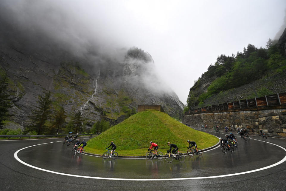 CASSANO MAGNAGO ITALY  MAY 20 A general view of the peloton compete racing down the to the Simplon Pass  Passo del Sempione 2004m during the 106th Giro dItalia 2023 Stage 14 a 194km stage from Sierre to Cassano Magnago  UCIWT  on May 20 2023 in Cassano Magnago Italy Photo by Tim de WaeleGetty Images