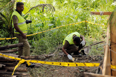 Police investigators work at the site of a blast behind the magistrates court in the town of Pugoda, 40 km (25 miles) east of the capital Colombo, Sri Lanka April 25, 2019. REUTERS/Thomas Peter