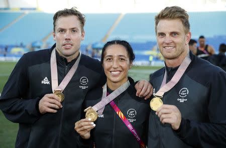 Rugby Sevens - Gold Coast 2018 Commonwealth Games - Men's Medals Ceremony - Robina Stadium - Gold Coast, Australia - April 15, 2018. Gold medalists Sarah Goss, Scott Curry and Tim Mikkelson of New Zealand pose with medals. REUTERS/Paul Childs