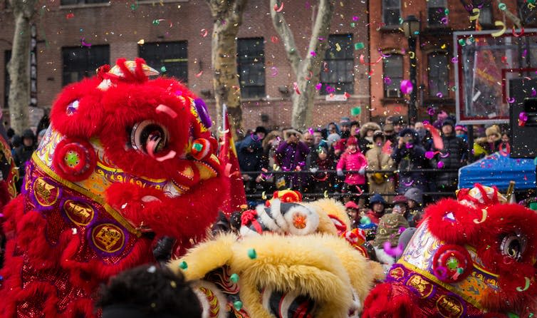 Crowds watching a lion dance during Lunar New Year.