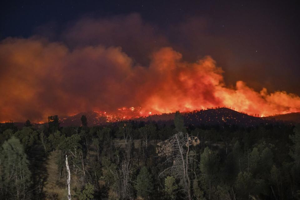 Flame are visible from the Zogg Fire on Clear Creek Road near Igo, Calif.