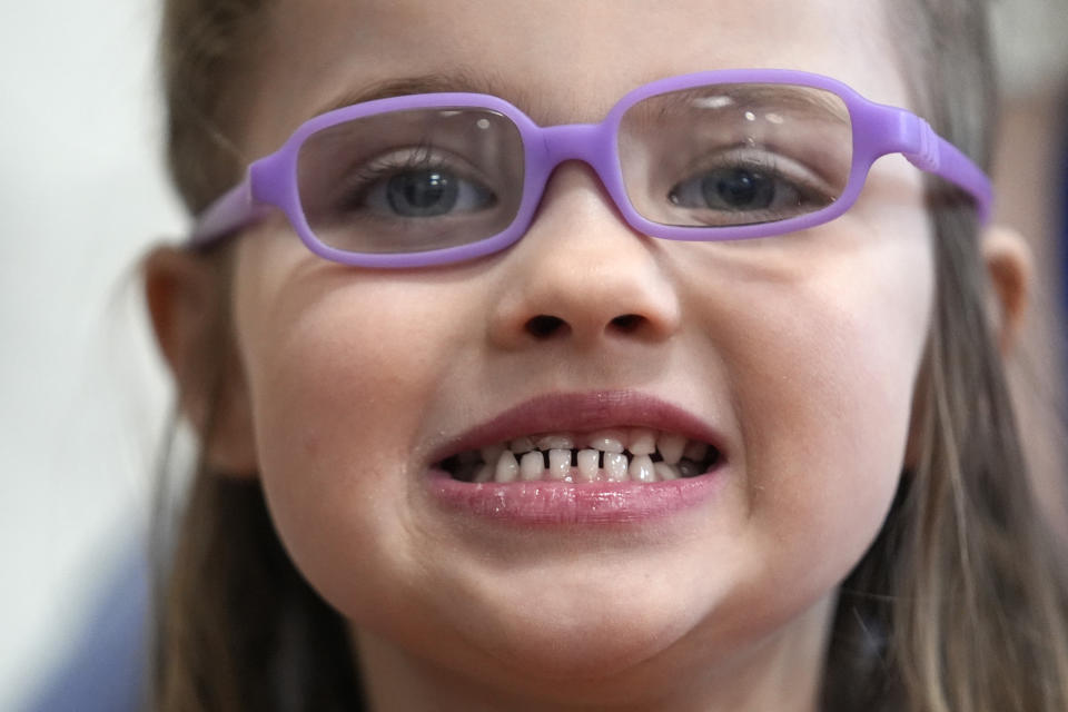 Amber Warner shows off her teeth after a dental exam at the Christa McAuliffe School in Concord, N.H., Wednesday, Feb. 21, 2024. The federal government and the dental community are increasing efforts to reach children at an early age. (AP Photo/Robert F. Bukaty)