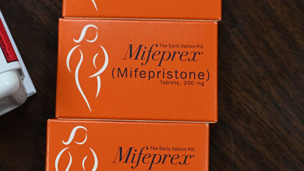  Close up of a orange box labeled "the early option pill Mifeprex". 