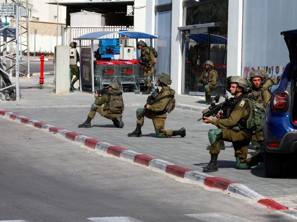 Israeli soldiers work to secure residential areas following a mass-infiltration by Hamas gunmen from the Gaza Strip, in Sderot, southern Israel October 7, 2023.