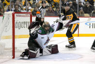 A shot by Pittsburgh Penguins' Bryan Rust (17) gets past Arizona Coyotes goaltender Karel Vejmelka (70) for a goal during the second period of an NHL hockey game in Pittsburgh, Tuesday, Jan. 25, 2022. (AP Photo/Gene J. Puskar)