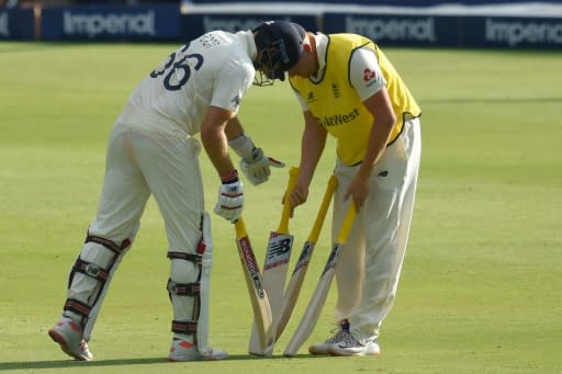 Last man out: England skipper Joe Root exchanges his bat for a new one on Sunday