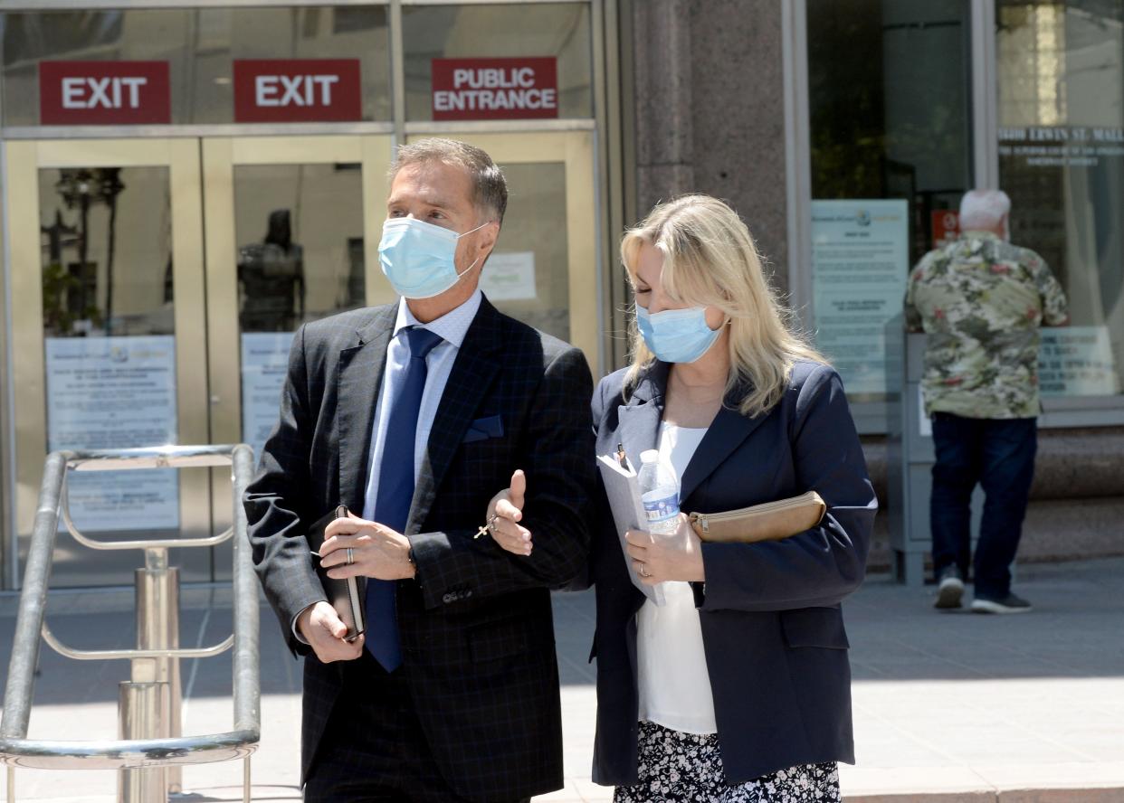 Rebecca Grossman, right, walks out of the Van Nuys courthouse in May 2022.
