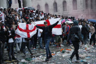 An England supporter waves a flag near Trafalgar Square in London, Sunday, July 11, 2021, during the Euro 2020 soccer championship final match between England and Italy which is being played at Wembley Stadium. (AP Photo/Peter Morrison)