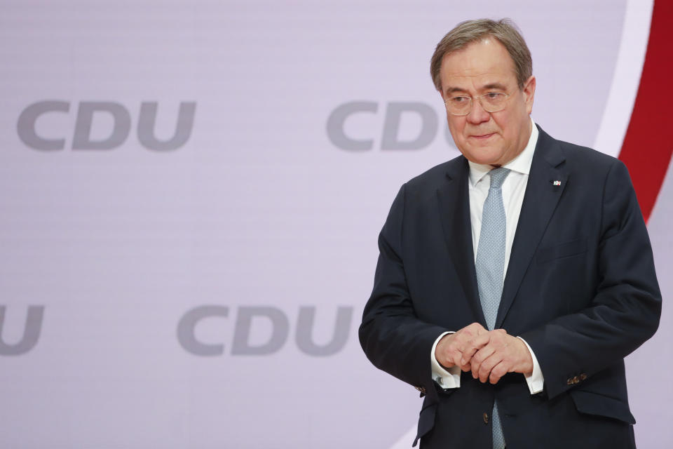 The new elected Christian Democratic Union, CDU, party chairman Armin Laschet stands on the podium after the voting at a digital party convention in Berlin, Germany, Saturday, Jan. 16, 2021. The party of German Chancellor Angela Merkel decided on a successor for the outgoing chairwoman Annegret Kramp-Karrenbauer at the convention. (AP Photo/Markus Schreiber)