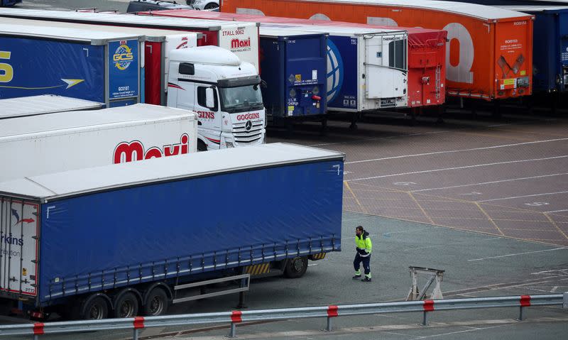 FILE PHOTO: A port worker looks at lorry trailers at the port of Holyhead in Wales, Britain