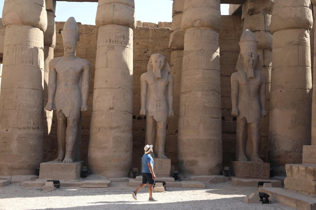 Tourists visit Luxor Temple on Friday, Nov. 26, 2021. (Mohamed El-Shahed/AP - image credit)