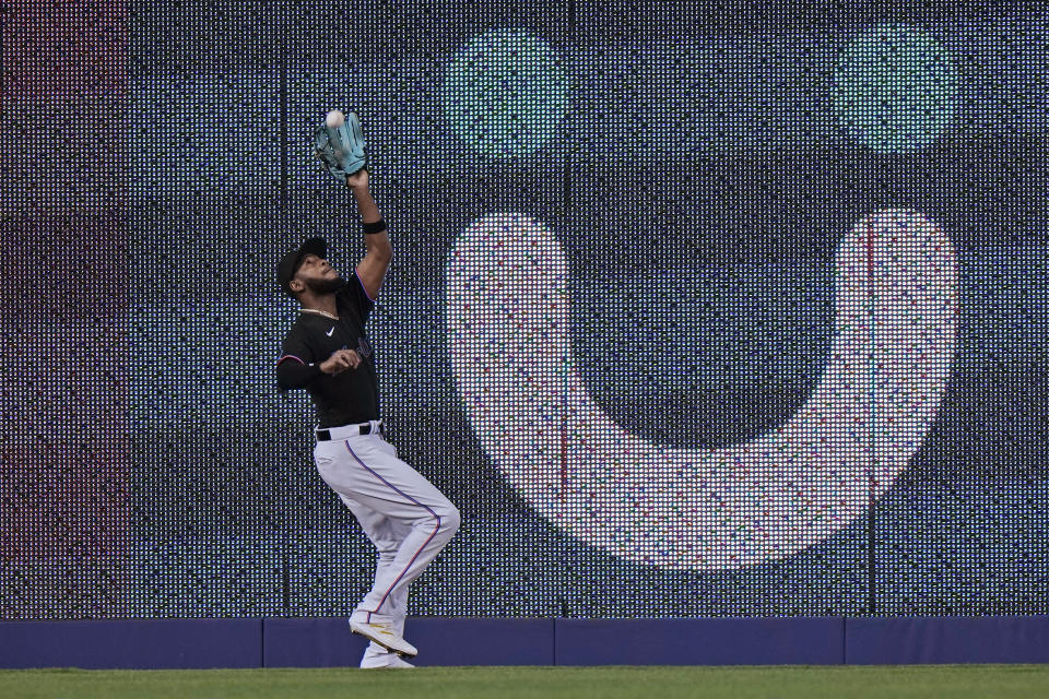 Miami Marlins left fielder Bryan De La Cruz catches a ball hit by Los Angeles Dodgers' Will Smith during the fifth inning of a baseball game, Thursday, Sept. 7, 2023, in Miami. (AP Photo/Wilfredo Lee)