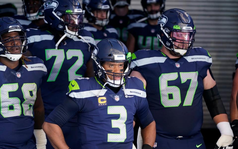 Seattle Seahawks quarterback Russell Wilson (3) stands with teammates in the tunnel before an NFL football game against the Dallas Cowboys, Sunday, Sept. 27, 2020, in Seattle.  - AP